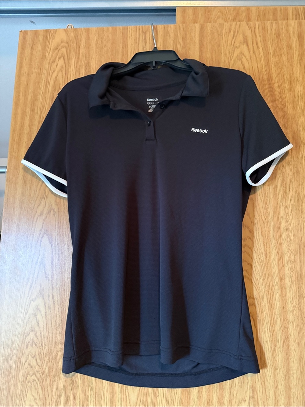 Reebok Women’s Black Polo Top with White Sleeve Trim